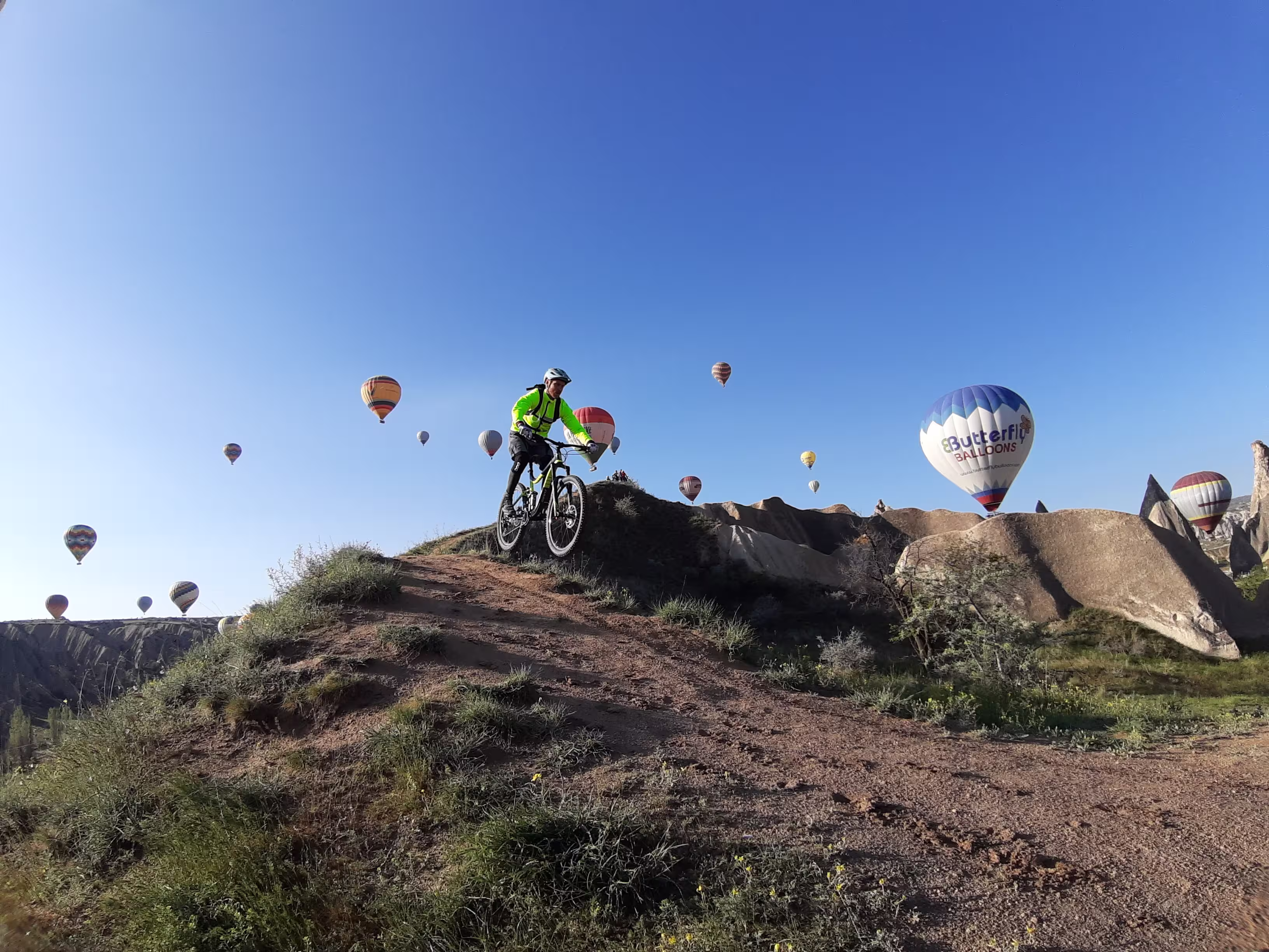 Older couple enjoying Cappadocia landscape on E-Bikes