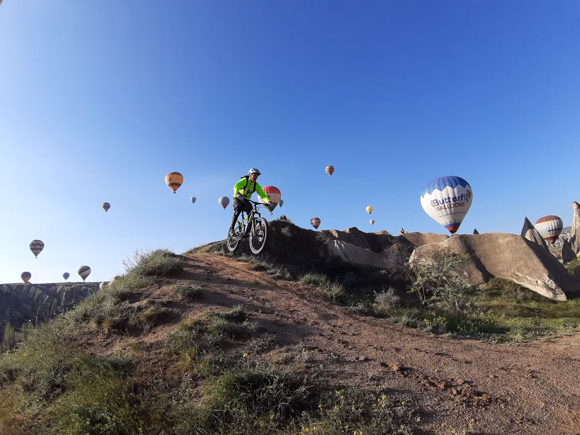 Older couple enjoying Cappadocia landscape on E-Bikes